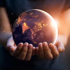 Hands holding a glowing globe representing the disruption of old models for a new world