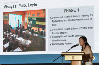 Woman giving talk in front of a projected screen