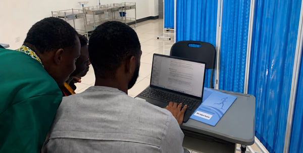 Ghanaian physiotherapists consulting an AI tool on a laptop in the clinic