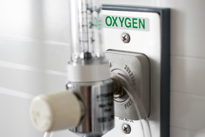 Close up of a hospital oxygen outlet with hose