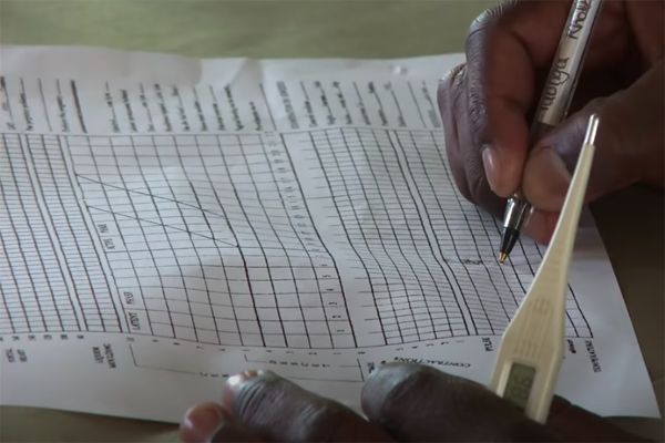 Healthcare worker filling out a partogram