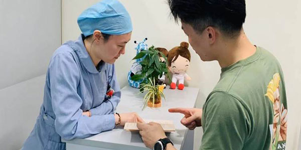 Nurse talking to a family member in a private room.