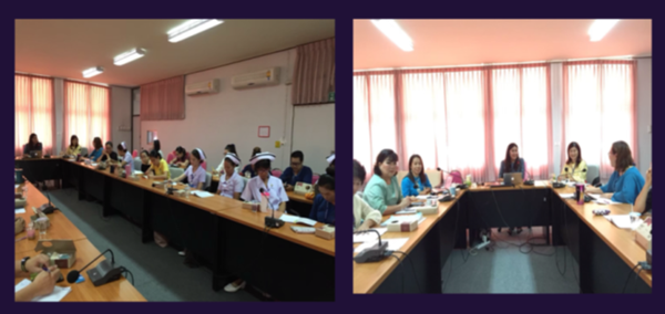 A group of clinicians sit in a conference room.