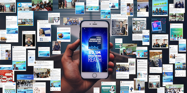 Snapshot of digital engagement in the background, with a hand holding a phone in the foreground displaying the World EBHC Day logo and 80.1M social media reach