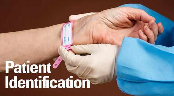 Close up of a clinician putting an identification bracelet on a patient